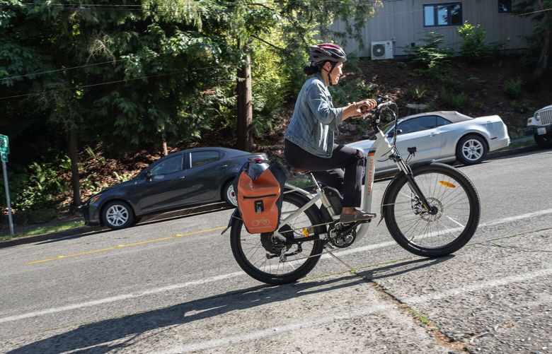 Nicole Tsong climbs a hill from Seward Park.  

Nicole Tsong tries commuting on an E-Bike, along Lake Washington and Seward Park.  

Photographed May 24, 2018. 206397