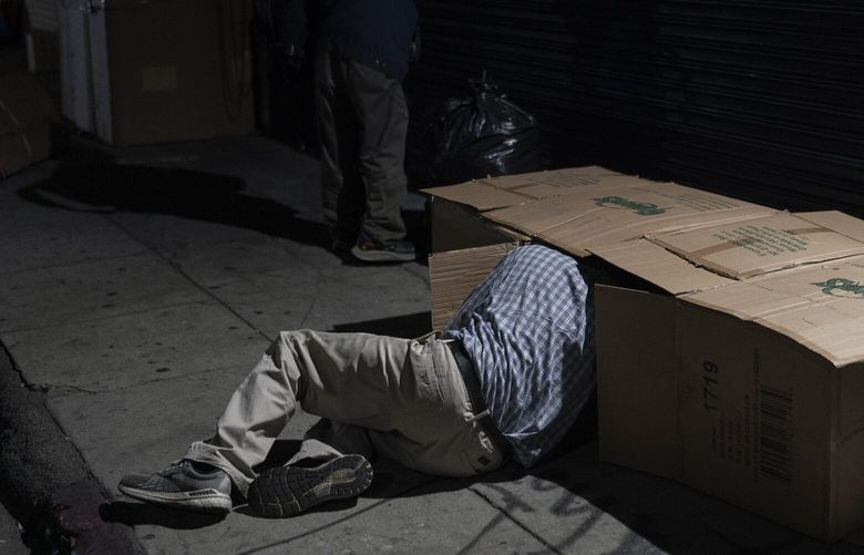FILE – David Hernandez, a 62-year-old homeless man, crawls into his bed made with cardboard boxes in Los Angeles, late Wednesday, Dec. 14, 2022. President Joe Biden’s Administration announced Monday, Dec. 19 it is ramping up efforts to help house people now sleeping on sidewalks, in tents and cars as a new federal report confirms what’s obvious to people in many cities: Homelessness is persisting despite increased local efforts. (AP Photo/Jae C. Hong, File) NY125 NY125