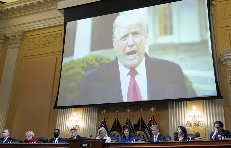 FILE – A video of President Donald Trump is shown on a screen, as the House select committee investigating the Jan. 6 attack on the U.S. Capitol holds a hearing at the Capitol in Washington, July 21, 2022. On Monday, Dec. 19, the House committee will make its final case to the American people about the unprecedented effort by former President Donald Trump to overturn the 2020 election and why the Justice Department should pursue criminal charges in connection to it. (AP Photo/J. Scott Applewhite, File) WX204 WX204