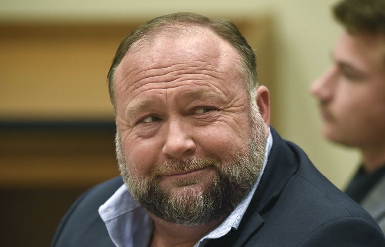 FILE – Infowars founder Alex Jones appears in court to testify during the Sandy Hook defamation damages trial at Connecticut Superior Court in Waterbury, Conn., on Sept. 22, 2022. A federal bankruptcy judge on Monday, Dec. 19, allowed cases to move forward regarding the nearly $1.5 billion Jones has been ordered to pay to families who sued him over his conspiracy theories about the Sandy Hook school massacre. (Tyler Sizemore/Hearst Connecticut Media via AP, Pool, File) CTBRP101 CTBRP101