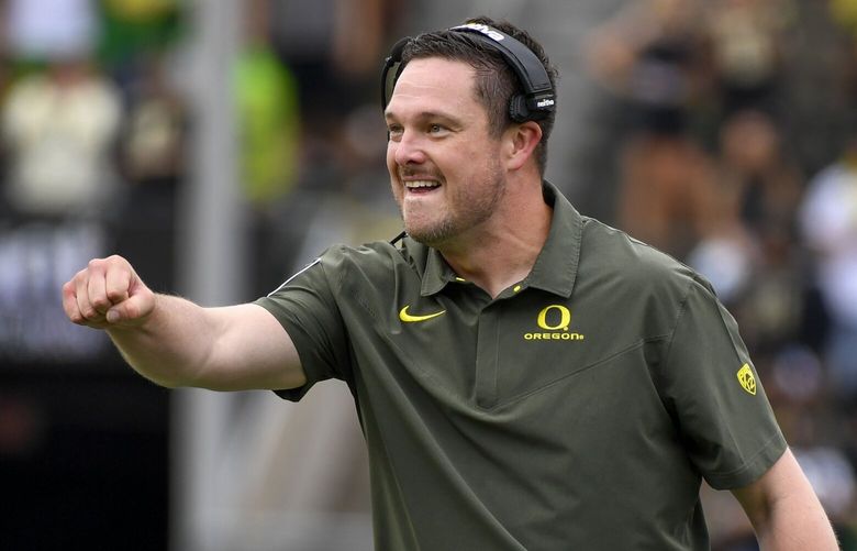 FILE – Oregon coach Dan Lanning reacts to a play against BYU during the first half of an NCAA college football game Sept. 17, 2022, in Eugene, Ore. The early signing period for college football opened Wednesday, Dec. 21. Oregon received commitments from five-star defensive back Peyton Bowen of Texas and four-star running back Jayden Limar from Washington. Both had been committed verbally — and very much nonbinding — to Notre Dame. Lanning and his staff also flipped four-star defensive back Daylen Austin from an LSU pledge and four-star quarterback Austin Novosad from a Baylor commitment. (AP Photo/Andy Nelson, File) NYDB501 NYDB501