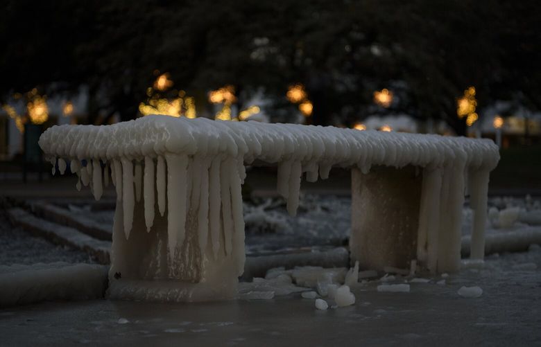 A park bench covered in ice, in Houston, Texas on Dec. 24, 2022. Much of the United States is experiencing the coldest Christmas Eve in decades, including in places unaccustomed to freezing temperatures, like parts of Texas, Louisiana and Florida. (Callaghan O’Hare/The New York Times) XNYT139 XNYT139
