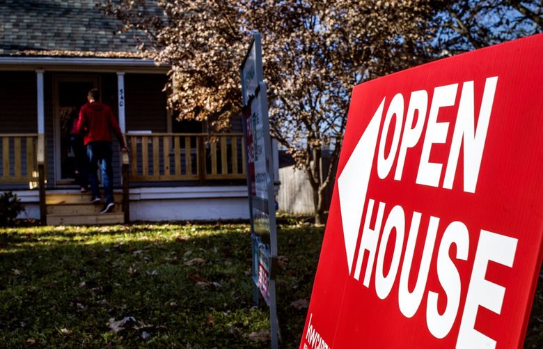 An “Open House” sign is displayed as potential home buyers arrive at a property for sale in Columbus, Ohio, in 2017. (Ty Wright/Bloomberg)