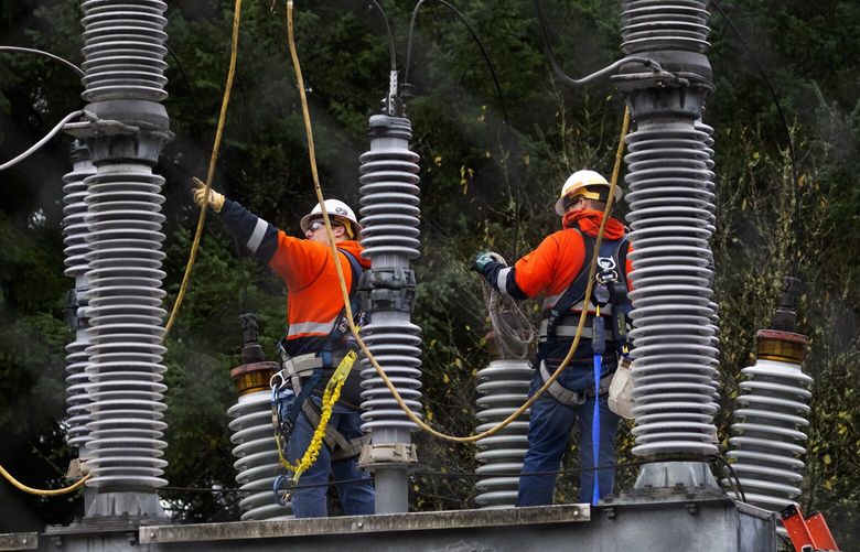 A Tacoma Power crew works at an electrical substation damaged by vandals early on Christmas morning, Sunday, Dec. 25, 2022 in Graham, which caused power outages.