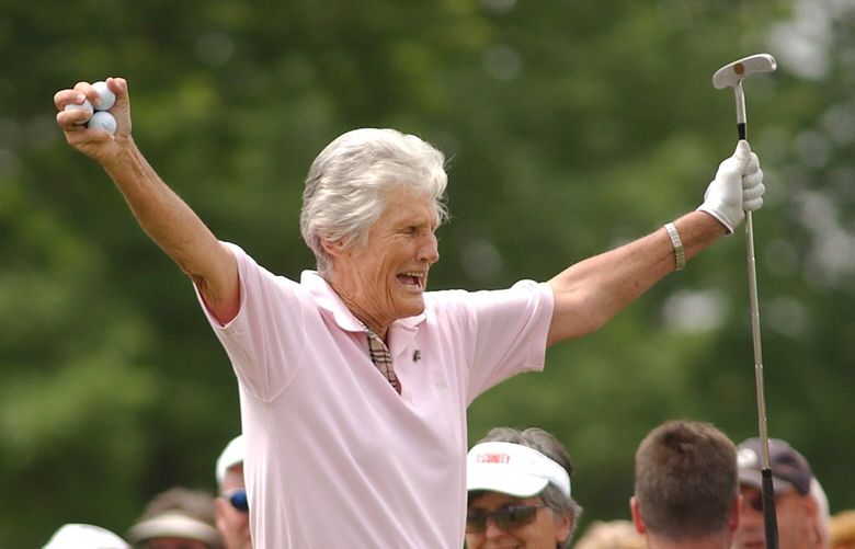 Kathy Whitworth responds to the crowd as she prepares to tee off during the Tournament of Champions golf tournament at Locust Hill Country Club in Pittsford, N.Y. on June 20, 2006. Former LPGA Tour player Whitworth, whose 88 victories are the most by any golfer on a single professional tour, died on Saturday, Dec. 24, 2022, night, her longtime partner said. She was 83. (Carlos Ortiz/Democrat & Chronicle via AP, File)