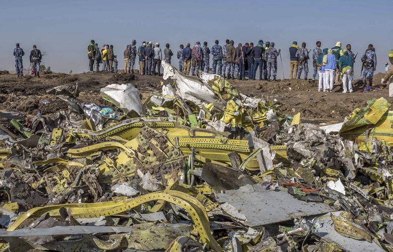 FILE – Wreckage is piled at the crash scene of Ethiopian Airlines flight ET302 near Bishoftu, Ethiopia, March 11, 2019. U.S. crash investigators say Ethiopian authorities failed to consider all factors that contributed to a deadly 2019 crash after a key flight-control system malfunctioned on a Boeing 737 Max airplane. (AP Photo/Mulugeta Ayene, File)