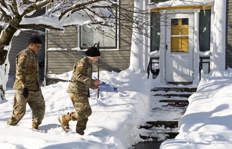 National guard members check on residents, Wednesday, Dec. 28, 2022, in Buffalo N.Y., following a winter storm. (AP Photo/Jeffrey T. Barnes) NYJB107 NYJB107