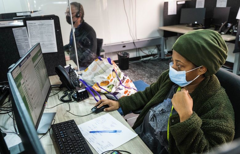 Crisis Line phone workers take calls at Crisis Connections Friday, April 8, 2022.  Soon they’ll be taking mental health calls made to the new 988 service. 220004