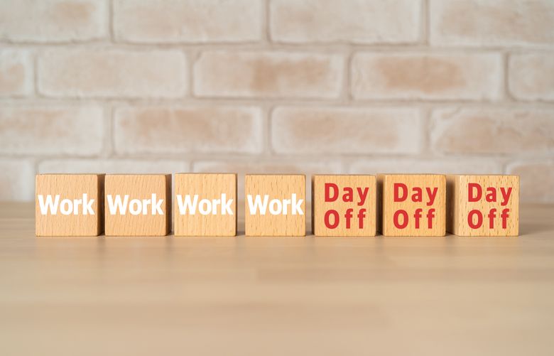 Wooden blocks with “Work” and “Day Off” text of concept.