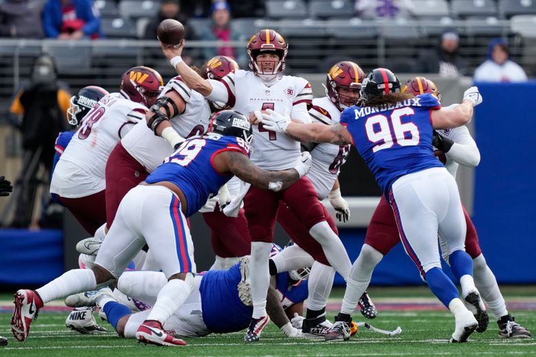 Washington Commanders quarterback Taylor Heinicke (4) throws under