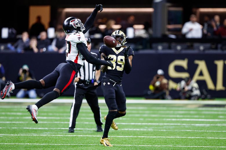 Andy Dalton of the New Orleans Saints scrambles with the ball in