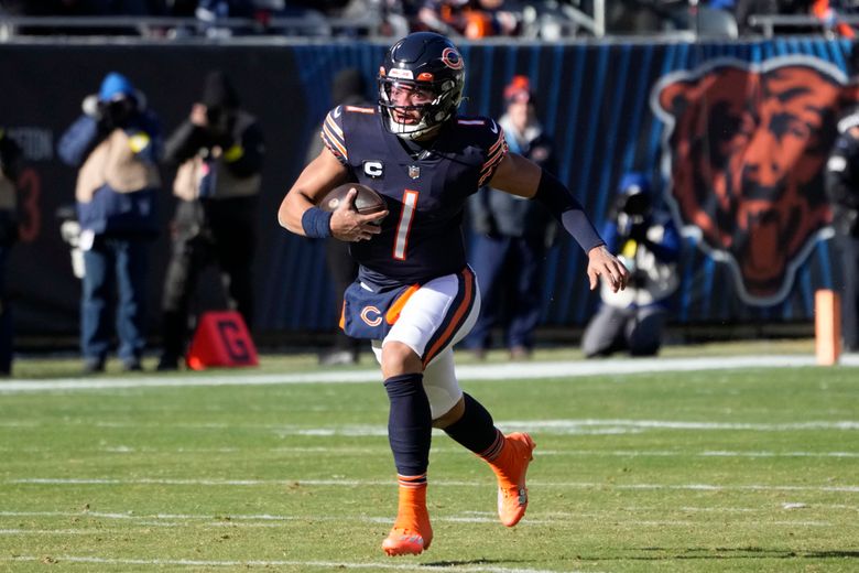 Chicago Bears quarterback Justin Fields runs against the