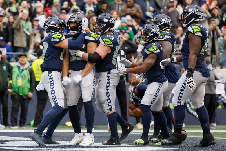 Teammates celebrate with Seattle Seahawks tight end Tyler Mabry after Mabry scored on a seven-yard touchdown pass during the second quarter.  (Jennifer Buchanan/The Seattle Times)