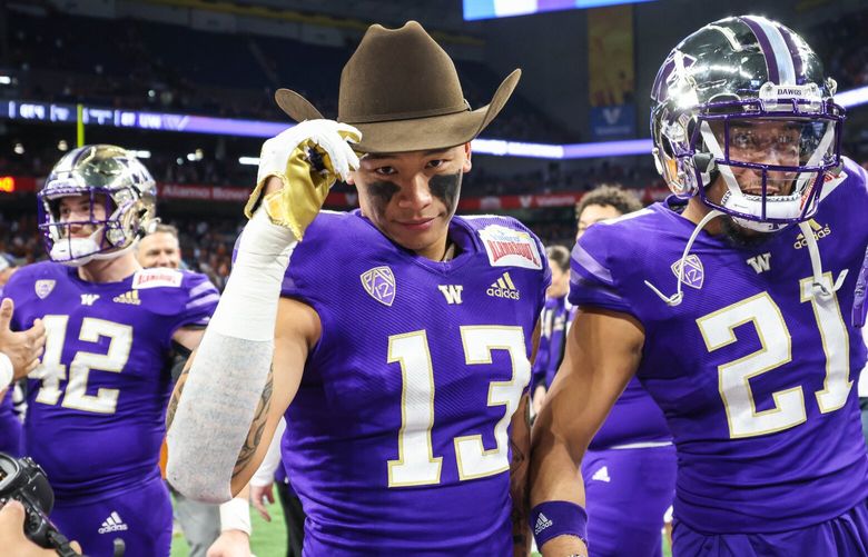 Kamren Fabiculanan dons a cowboy hat after the Huskies beat Texas in the Alamo Bowl. 222561