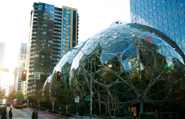Pedestrians walk by Amazon’s Spheres at the corner of Seventh Avenue and Lenora Street in Seattle on Tuesday, Nov. 15, 2022. 222198
