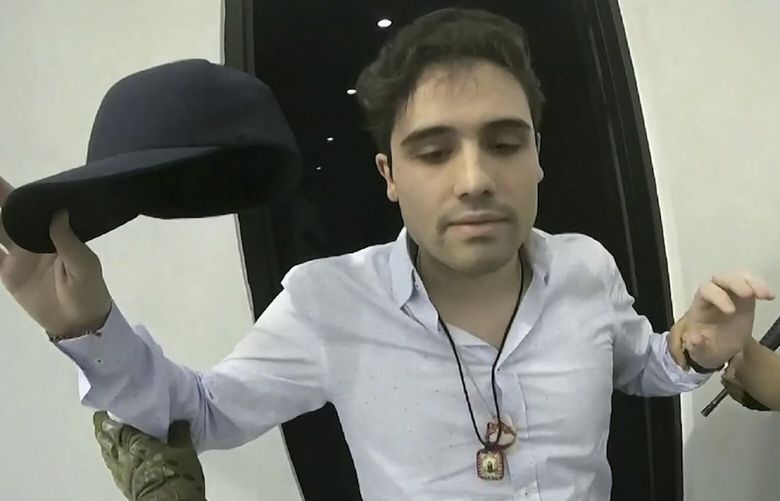 FILE – This Oct. 17, 2019 frame grab from video provided by the Mexican government shows Ovidio Guzman Lopez at the moment of his detention, in Culiacan, Mexico. Mexican security forces were forced to release the son of Sinaloa cartel leader Joaquin “El Chapo” Guzman that day after his gunmen shot up the western city of Culiacan.  (CEPROPIE via AP File) XLAT102