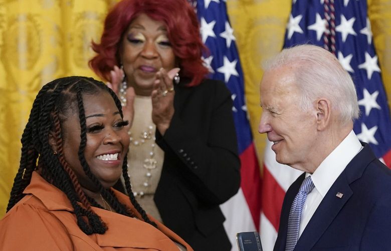 Ruby Freeman stands and applauds as President Joe Biden awards the Presidential Citizens Medal, the nation’s second-highest civilian honor, to her daughter Shaye Moss, a former Georgia election worker, during a ceremony to mark the second anniversary of the Jan. 6 assault on the Capitol in the East Room of the White House in Washington, Friday, Jan. 6, 2023. (AP Photo/Patrick Semansky) DCPS438 DCPS438