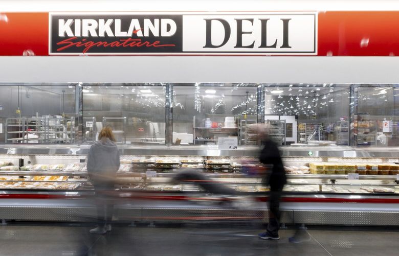 Shoppers move through Costco in College Station, Texas, on Wednesday, Dec. 21, 2022. (Logan Hannigan-Downs/College Station Eagle via AP)