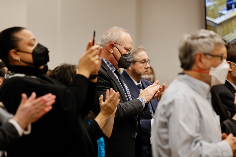 King County Prosecutor Dan Satterberg claps before Leesa Manion is sworn in as his replacement at a ceremony at the King County Courthouse. (Jennifer Buchanan / The Seattle Times)