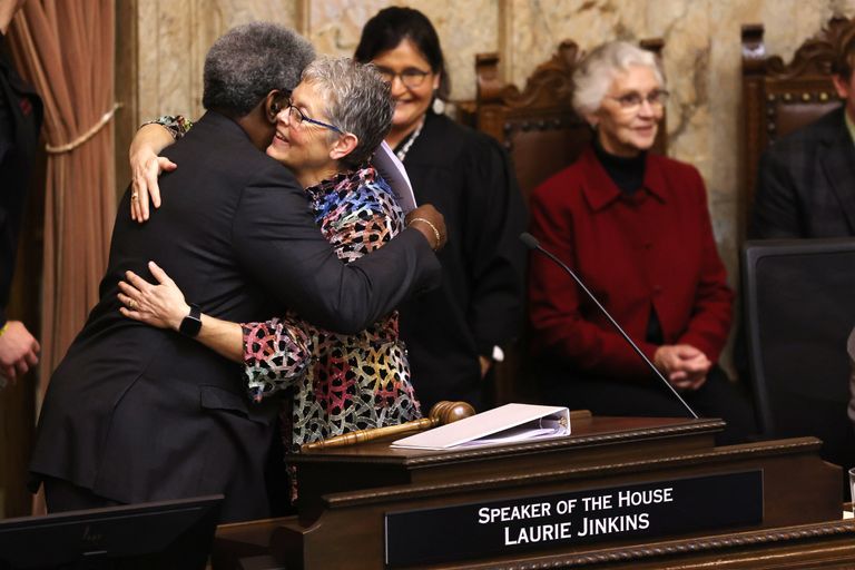 Speaker of the House Laurie Jinkins, D-Tacoma, hugs pastor Gregory Christopher of the Shiloh Baptist Church in Tacoma Monday as the new legislative session opened.