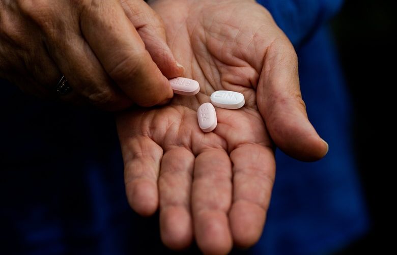 FILE — A patient with pills of Paxlovid in Santa Barbara, Calif., Jan. 6, 2021. Very few people take the antiviral medicine, but there are good reasons for certain COVID patients to consider it. (Alex Welsh/The New York Times) XNYT26 XNYT26