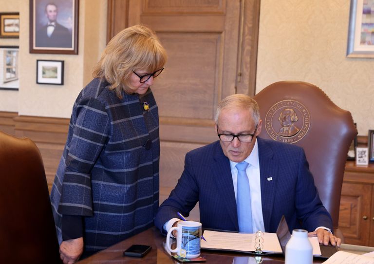 Trudi Inslee, wife of Gov. Jay Inslee, looks over his shoulder as he prepares his 2023 State of the State address Tuesday morning in the governor’s office at the Capitol.