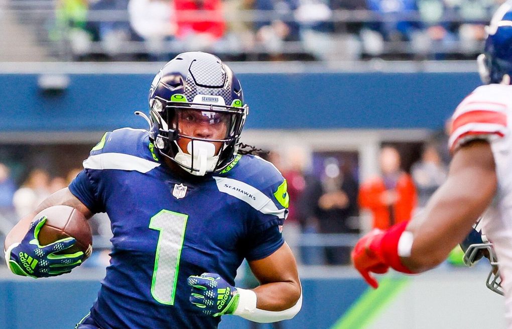 Seattle Seahawks wide receiver Dee Eskridge kneels on the field