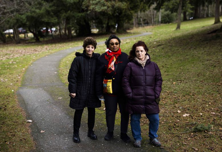 Community members (from left) Marie Sciacqua, Cynthia Ricks-Maccotan and Suzanne Vargo oppose razing Steel Lake Park Annex. It has ballfields, shaded walking paths, a play structure and Federal Way&#8217;s only skatepark. (Daniel Kim / The Seattle Times)