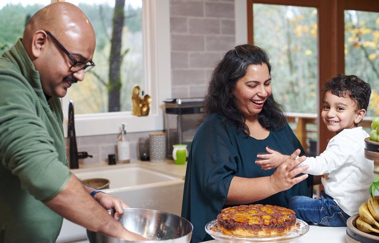 Newcastle family, from left, Ashish, Abhilasha and Abir Parida with a finished pineapple upside down cake. Ashish is making his way through his family’s recipes, and hopes to open a restaurant one day.