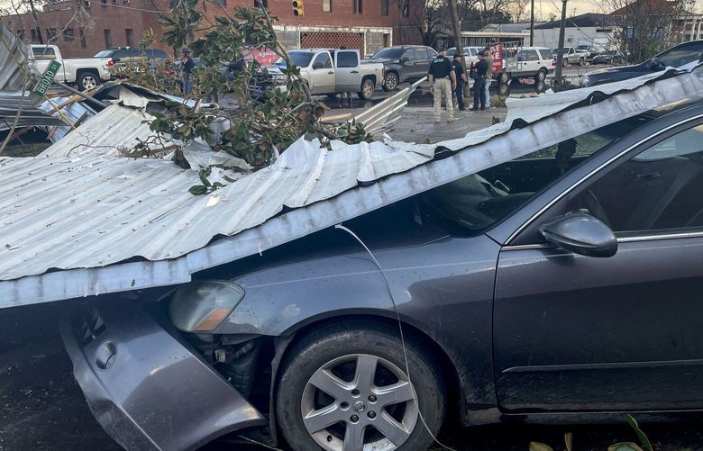A damaged vehicle and debris are seen in the aftermath of severe weather, Thursday, Jan. 12, 2023, in Selma, Ala. A large tornado damaged homes and uprooted trees in Alabama on Thursday as a powerful storm system pushed through the South. (AP Photo/Butch Dill) ALBD204 ALBD204