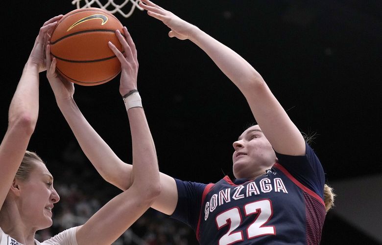 Stanford forward Cameron Brink, left, battles for a rebound against Gonzaga guard Brynna Maxwell, right, during the second half of an NCAA college basketball game in Stanford, Calif., Sunday, Dec. 4, 2022. (AP Photo/Tony Avelar)