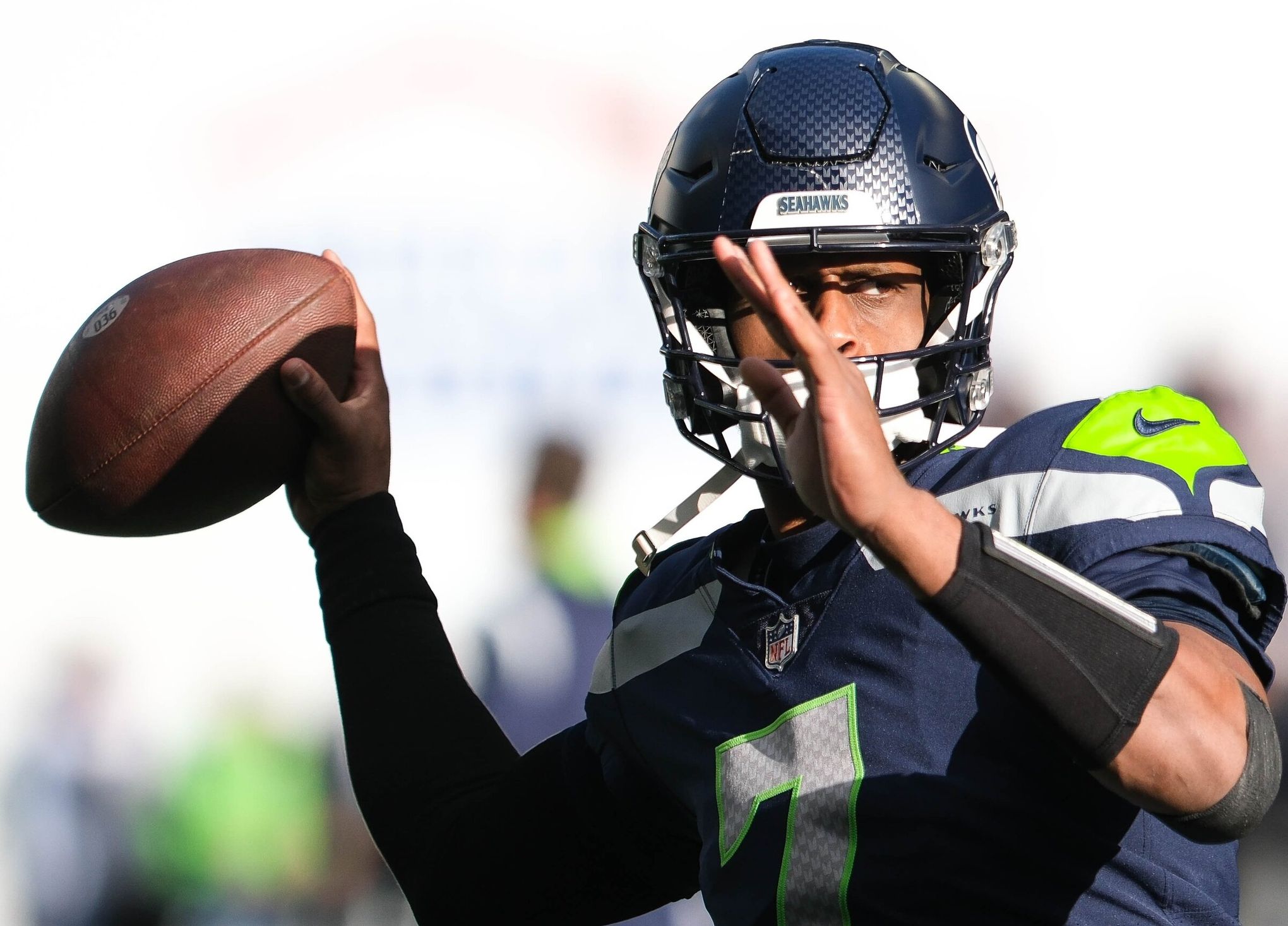 A Seattle Seahawks fan wearing a Russell Wilson jersey waves a