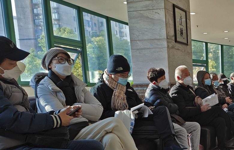 Family members of the deceased wait for the cremation procedures at a funeral home in Shanghai, China on Jan. 4, 2023. China on Saturday, Jan. 14, reported nearly 60,000 deaths in people who had COVID-19 since early December following complaints the government was failing to release data about the status of the pandemic. (Chinatopix Via AP) XAW802 XAW802