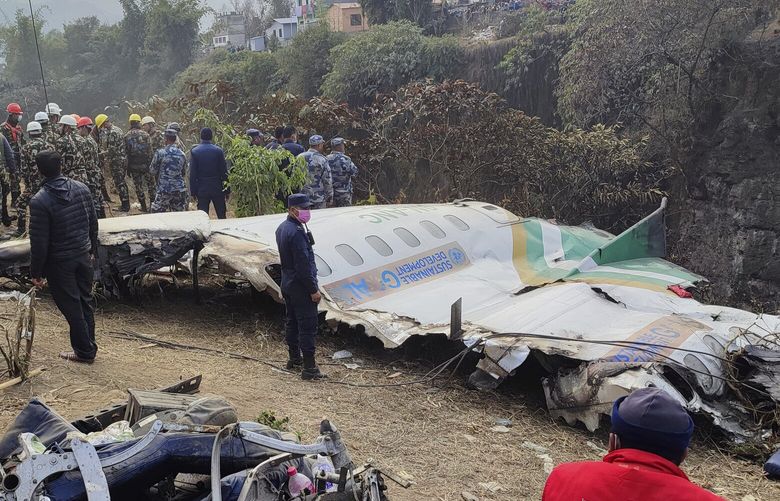 Rescuers stand by wreckage of a passenger plane that crashed in Pokhara, Nepal, Monday, Jan 16, 2023. A spokesman for Nepal’s Civil Aviation Authority says a flight data recorder and a cockpit voice recorder have been retrieved from the site of the crash of a passenger plane that went down on approach to a newly opened airport in the tourist town of Pokhara. (AP Photo/Anish Bhattarai) NEP102 NEP102