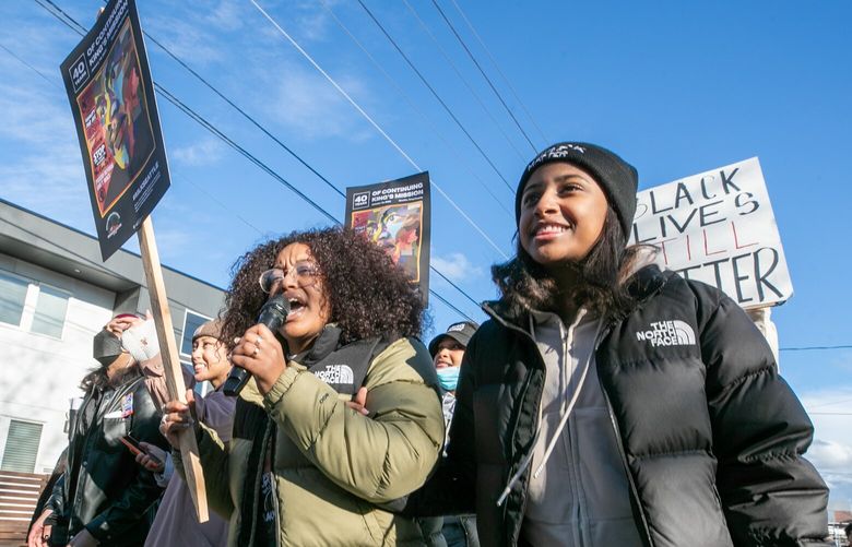 Elul Adoga, left, leads a rallying cheer with Semayat Yewondwossen during the annual Dr. Martin Luther King Jr. March Monday afternoon in Seattle, Washington on January 16, 2023.