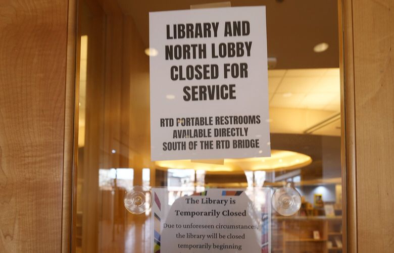 Signs are placed on the outside doors to advise visitors that the library as well as a restroom are closed because of meth contamination Thursday, Jan. 12, 2022, in the south Denver suburb of Englewood, Colo. (AP Photo/David Zalubowski) CODZ101 CODZ101