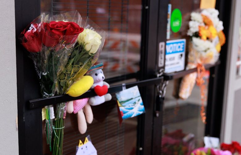 Flowers, candles and cards are seen at a memorial outside Rainier Teriyaki, located at 3330 Rainier Ave S., in Seattle Tuesday, Jan. 17, 2023.  222797