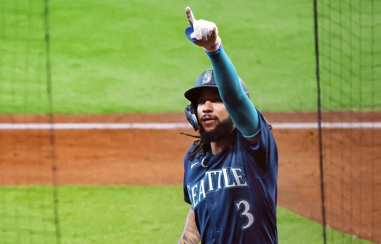 Seattleís J.P. Crawford points to a small but vocal crowd of Mariners fans after Crawford hit a solo home run during the fourth inning. 221812