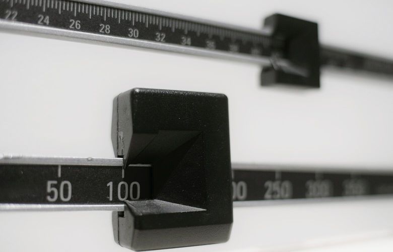 FILE – This Tuesday, April 3, 2018 photo shows a closeup of a beam scale in New York. A report released on Wednesday, Dec. 18, 2019 says nearly half of American adults will be obese within a decade and one-quarter will be severely so. (AP Photo/Patrick Sison)