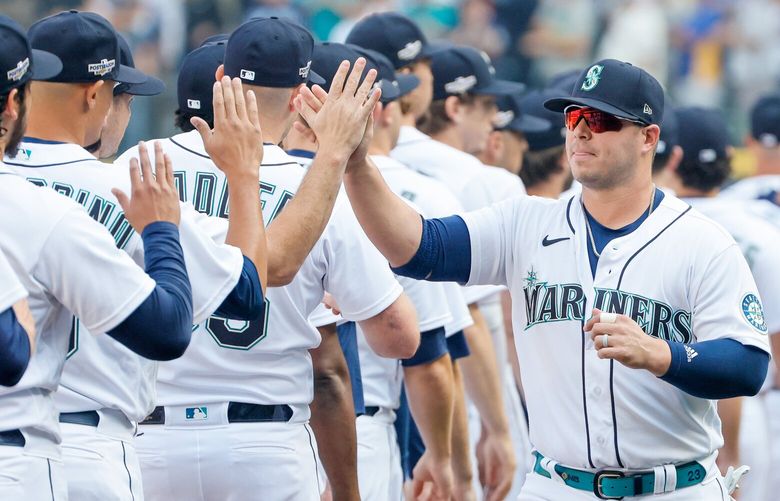 Seattle Mariners first baseman Ty France slaps hands with his teammates before the start of game three of the ALDS. 221880