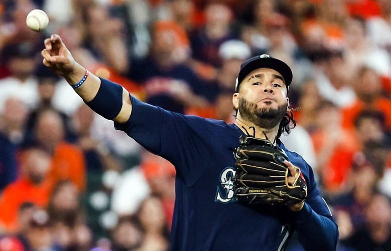 Eugenio Suarez tries to make the throw to first on a high chop in the sixth inning as the Seattle Mariners play the Houston Astros in Game 1 of the American League Division Series Tuesday, Oct. 11, 2022 at Minute Maid Park, in Houston, TX.  221812
