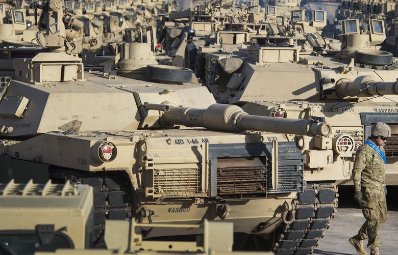 FILE – A soldier walks past a line of M1 Abrams tanks, Nov. 29, 2016, at Fort Carson in Colorado Springs, Colo.  In what would be a reversal, the Biden administration is poised to approve sending M1 Abrams tanks to Ukraine, U.S. officials said Tuesday, as international reluctance toward sending tanks to the battlefront against the Russians begins to erode. The decision could be announced as soon as Wednesday though it could take months or years for the tanks to be delivered.  (Christian Murdock/The Gazette via AP, File) WX103 WX103