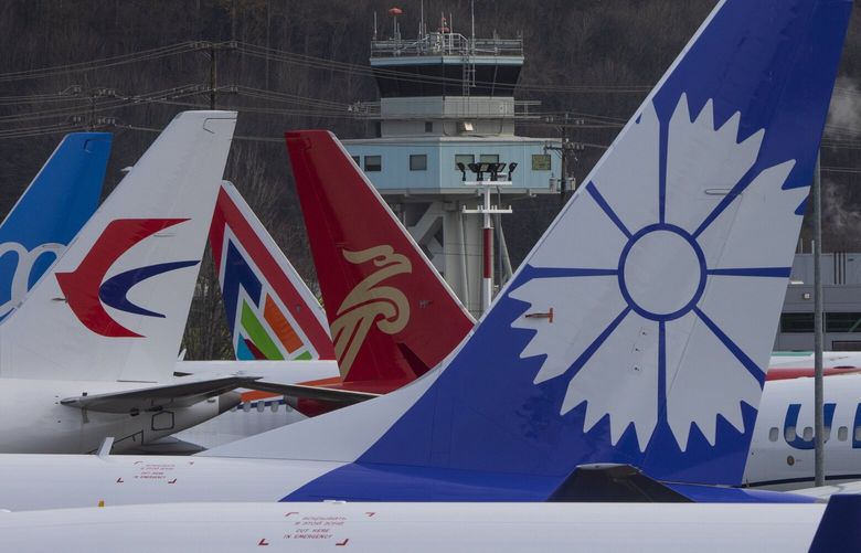 Boeing 737 MAX  planes are grounded on the west side of Marginal Way, across from Boeing Field in Seattle, shot Friday, December 17, 2021. The tower from Boeing Field can be seen in background.  219100