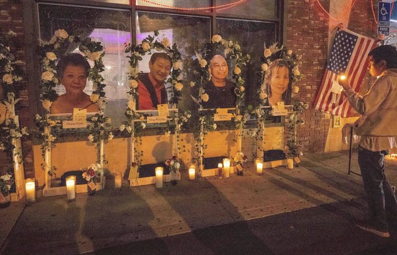 Eric Sham visits a makeshift memorial on Tuesday, Jan. 24, 2023 for those killed in a mass shooting at The Star Ballroom Dance Studio in Monterey Park. (Sarah Reingewirtz/The Orange County Register via AP) CAVAN211 CAVAN211