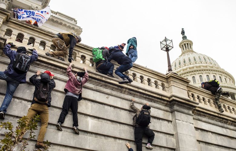 FILE — A mob made up of supporters of President Donald Trump storm the Capitol in Washington, on Jan. 6, 2021. In the past few days, the subject of violence — and the Proud Boys’s opinions of it — have taken center stage at the trial of five members of the group charged with seditious conspiracy in connection with the storming of the Capitol on Jan. 6, 2021. (Jason Andrew/The New York Times) XNYT82 XNYT82