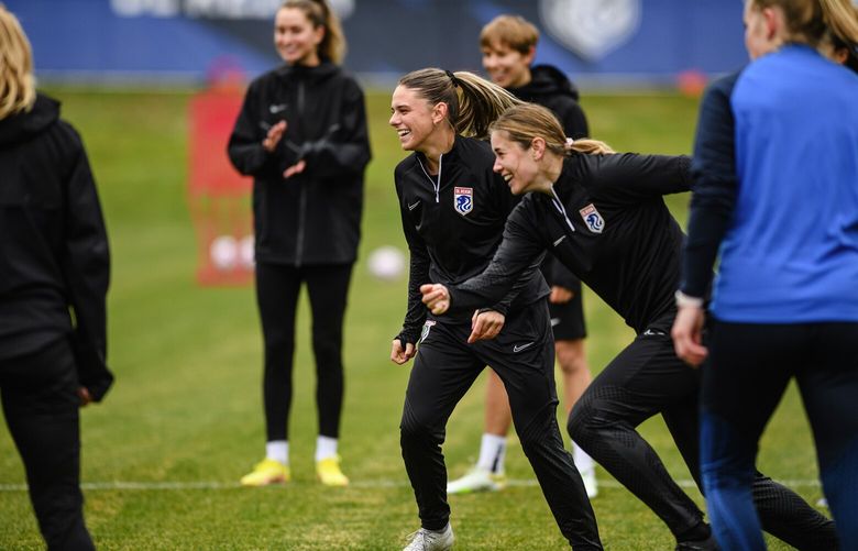OL Reign players Shae Holmes and Natalie Viggiano run together during a drill at the team’s new facility Starfire Sports in Tukwila on Wednesday. (Courtesy OL Reign)