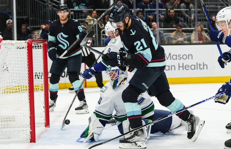 The Kraken take advantage of the power play getting Alex Wennberg (21) the puck at the crease, and scoring the second goal of the game against the Canucks in the first period.