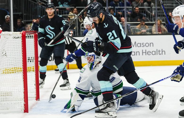 The Kraken take advantage of the power play getting Alex Wennberg (21) the puck at the crease, and scoring the second goal of the game against the Canucks in the first period. 222841