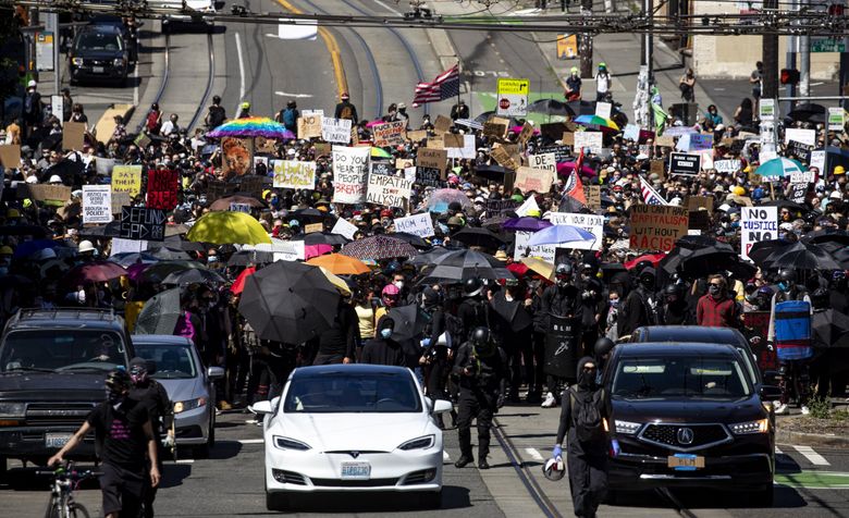 Planned protests for a “Youth Day of Action and Solidarity with Portland” take place in Seattle Saturday July 25, 2020. Tensions are high in reaction to federal law enforcement officers stoking clashes in Portland, escalating ongoing Black Lives Matter demonstrations into violent displays of force.  (Bettina Hansen / The Seattle Times)