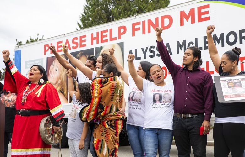 Roxanne White, left, leads the group gathered, including family of Alyssa McLemore to the right, in the Women’s Warrior song to close out the ceremony unveiling the truck wrapped in her photo and information at the State Capitol in Olympia Wednesday June 5, 2019. 210493
